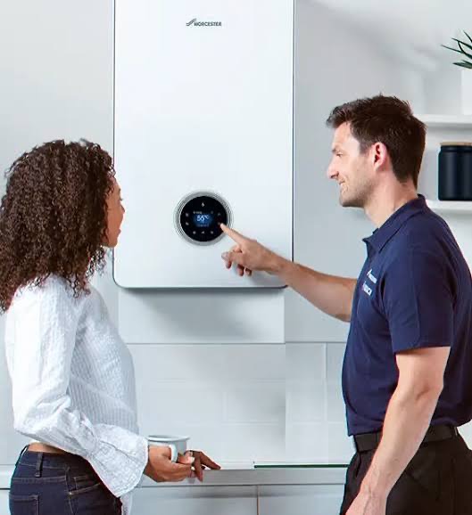 Gas Safe engineer showing a customer how to use a Worcester boiler